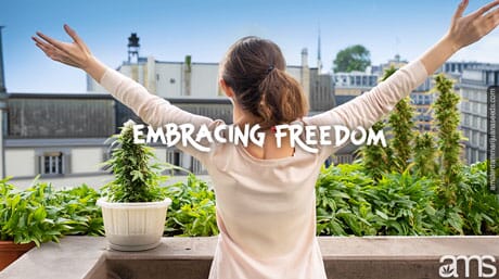 happy woman with open arms grows cannabis plants on the terrace