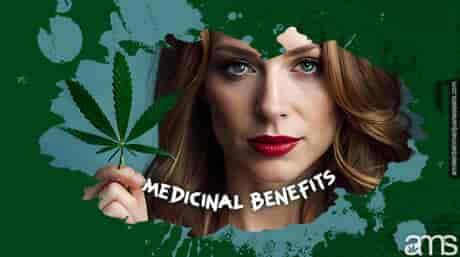 woman holds a cannabis leaf