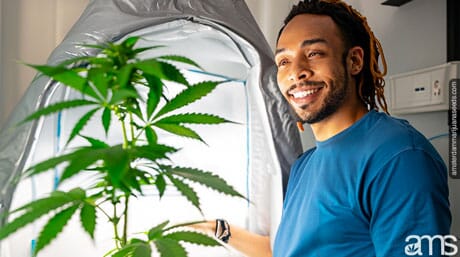 man in front of his grow tent