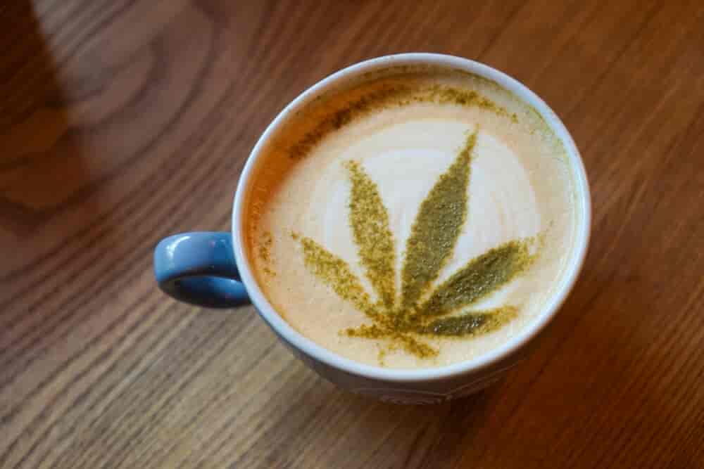 cappucino wih latte art in form of a cannabis leaf