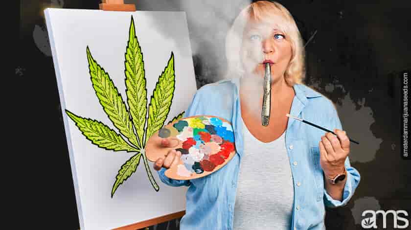 woman painting a cannabis leaf