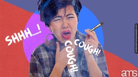 Coughing woman holding a joint