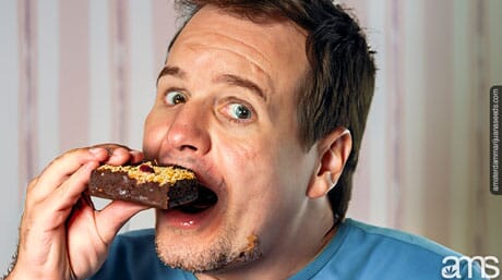 a man with big eyes eats an edible